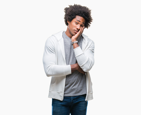 Afro american man wearing sweatshirt over isolated background thinking looking tired and bored with depression problems with crossed arms.