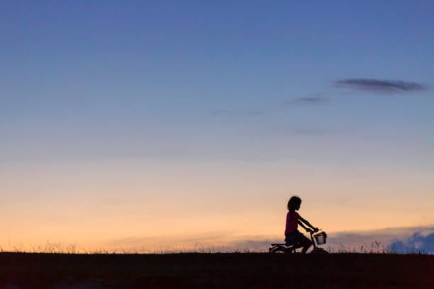 istock a girl riding bicycle 1042727806