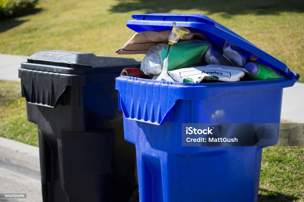 Trash Day A garbage and a recycling bin wait for pick collection. Recycling Bin Stock Photo