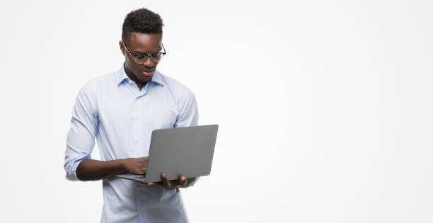 istock Young african american businessman using computer laptop with a confident expression on smart face thinking serious 1042737600