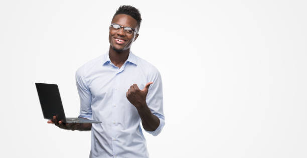istock Young african american businessman using computer laptop pointing with hand and finger up with happy face smiling 1042737616