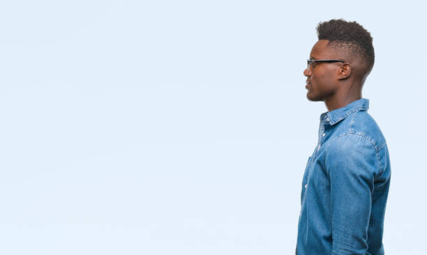 istock Young african american man over isolated background looking to side, relax profile pose with natural face with confident smile. 1042741490