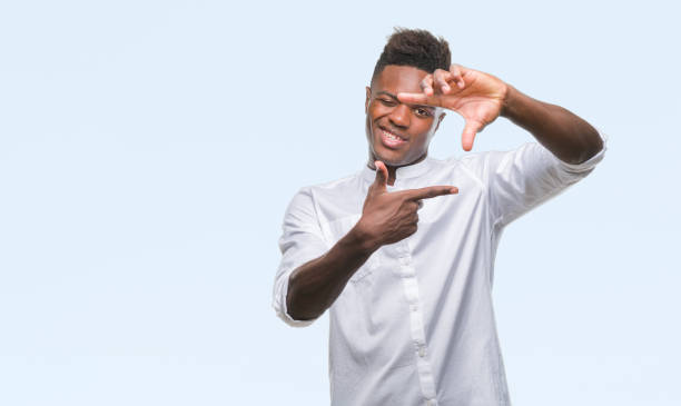 istock Young african american man over isolated background smiling making frame with hands and fingers with happy face. Creativity and photography concept. 1042741574