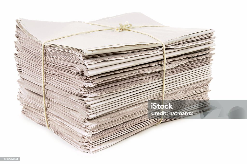 Newspapers tied with rope Bundle of new newspapers tied with rope.  Alternative file shown below: Newspaper Stock Photo