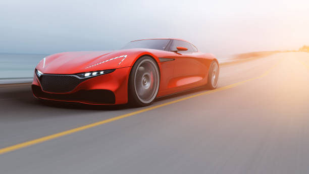 istock red car driving on a road by sea 1042759280
