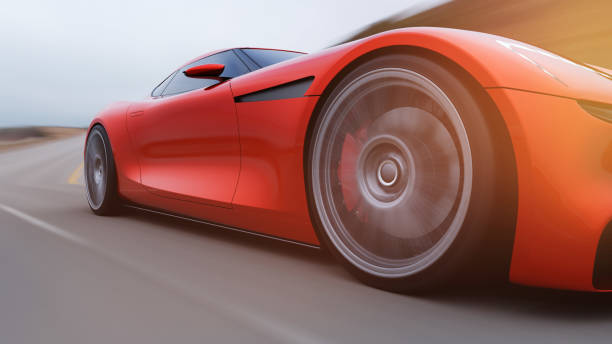 istock red car driving on a road by sea 1042759282
