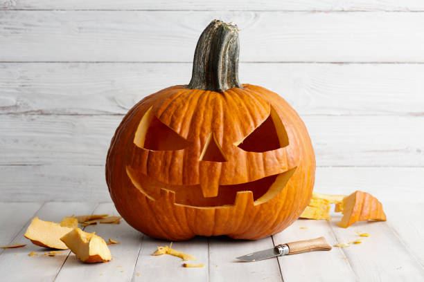 istock Carved Halloween pumpkin on white boards 1042759966