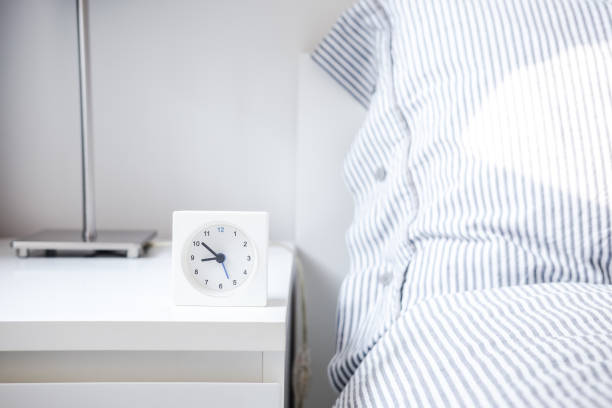 istock Alarm clock in white bedroom iterior 1042760180