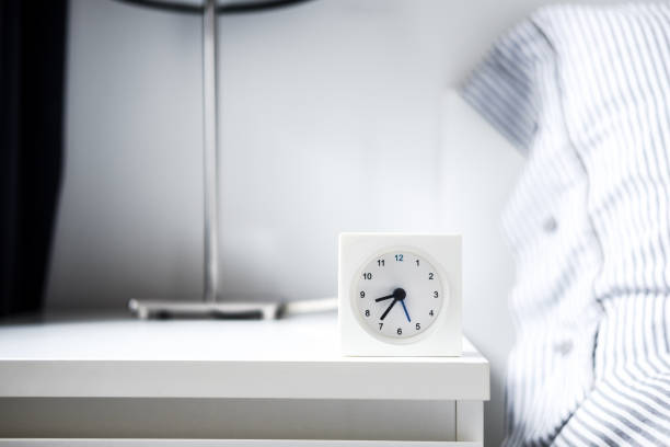 istock Alarm clock in white bedroom iterior 1042760184