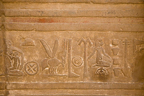 Painted Egyptian Hieroglyphs on the walls of the tomb of the Pharoah Rameses IV at the archaeological site in the Valley of Kings.