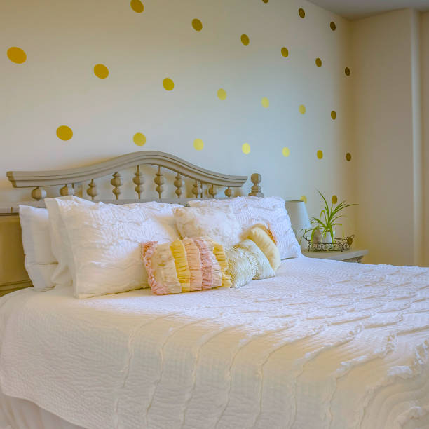 istock Cozy bed with white beddings and bedside table 1042765874