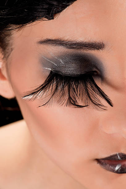 Extreme makeup with feather eyelashes stock photo