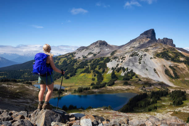 Girl hiking Panorama Ridge in Garibaldi Adventurous girl enjoying the beautiful Canadian Mountain Landscape during a vibrant summer day. Taken in Garibaldi Provincial Park, located near Whister and Squamish, North of Vancouver, BC, Canada. garibaldi park stock pictures, royalty-free photos & images