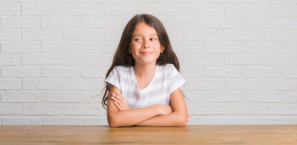 Portrait of cute little girl with long light hair  in white t-shirt
