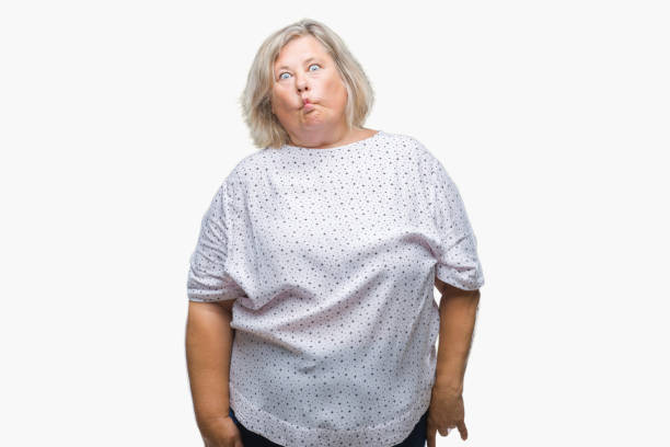 istock Senior plus size caucasian woman over isolated background making fish face with lips, crazy and comical gesture. Funny expression. 1042792796