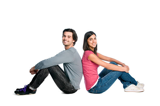 sorridente giovane coppia seduta insieme - sedere per terra foto e immagini stock