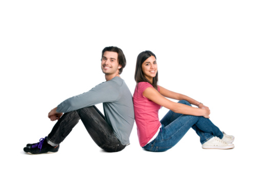Happy young beautiful latin couple relaxing together while sitting isolated over white background.