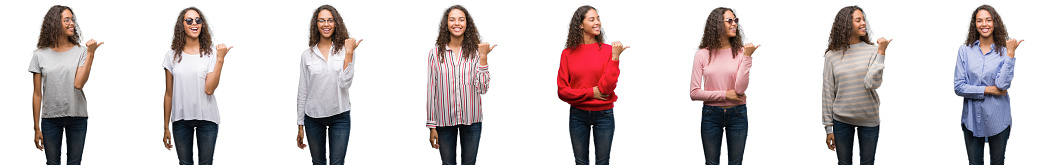 Composition of young brazilian woman isolated over white background smiling with happy face looking and pointing to the side with thumb up.