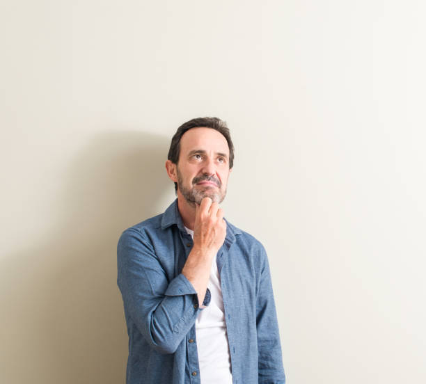 istock Senior man serious face thinking about question, very confused idea 1042799444