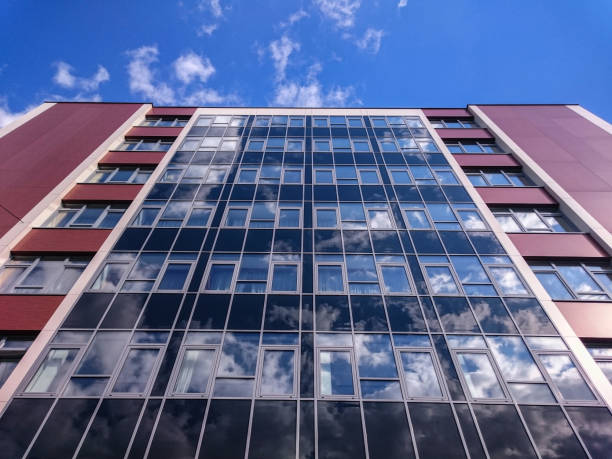 istock Clouds reflecting on the windows of an office building 1042799590