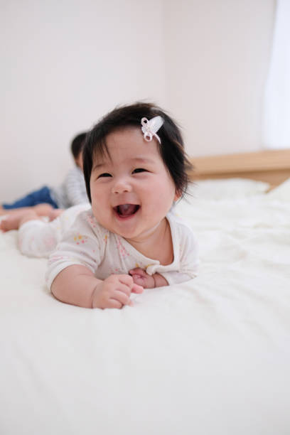istock Smiling female baby lying on the bed 1042799814