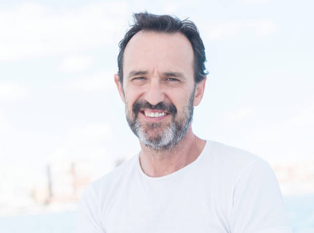 istock Handsome senior man sailing on a sailboat 1042799854