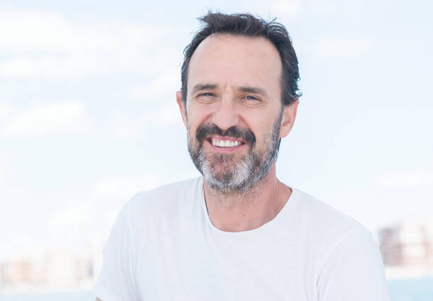 istock Handsome senior man sailing on a sailboat 1042799960