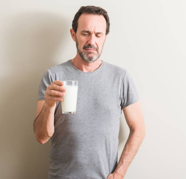 istock Senior man drinking a glass of milk with a confident expression on smart face thinking serious 1042800170