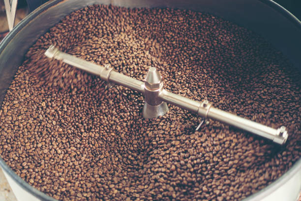 istock fresh coffee beans in roast machine, arabica roasted coffee ,vintage filter image 1042808736