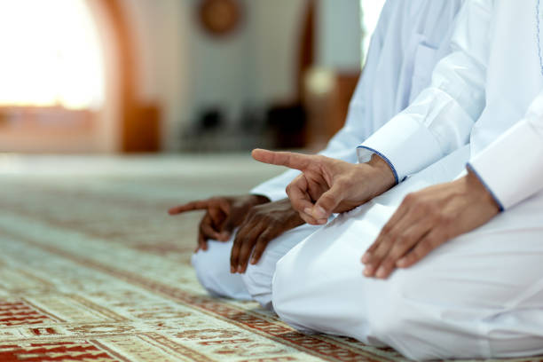 istock Muslim men praying with holy books in mosque 1042808762