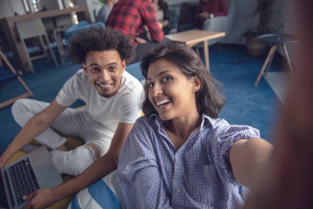 istock Group of happy smiling businesspeople making selfie and gesturing. 1042811006