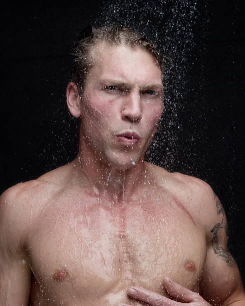 istock Beautiful man taking a shower - headshot 1042811360