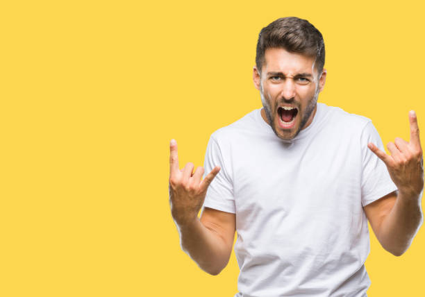 istock Young handsome man over isolated background shouting with crazy expression doing rock symbol with hands up. Music star. Heavy concept. 1042816378