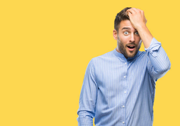 istock Young handsome man over isolated background surprised with hand on head for mistake, remember error. Forgot, bad memory concept. 1042816458