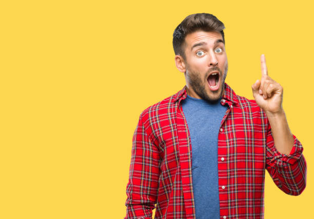 istock Young handsome man over isolated background pointing finger up with successful idea. Exited and happy. Number one. 1042816570