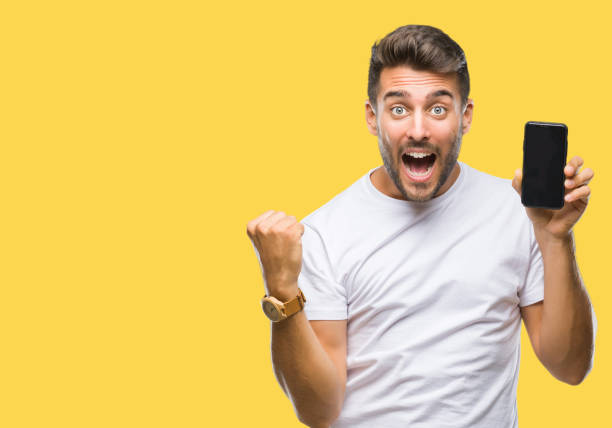 istock Young handsome man showing smartphone screen over isolated background screaming proud and celebrating victory and success very excited, cheering emotion 1042816778