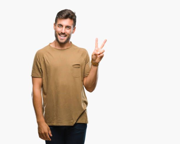 istock Young handsome man over isolated background smiling with happy face winking at the camera doing victory sign. Number two. 1042817190