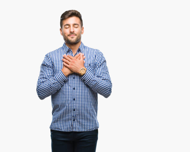 istock Young handsome man over isolated background smiling with hands on chest with closed eyes and grateful gesture on face. Health concept. 1042817206
