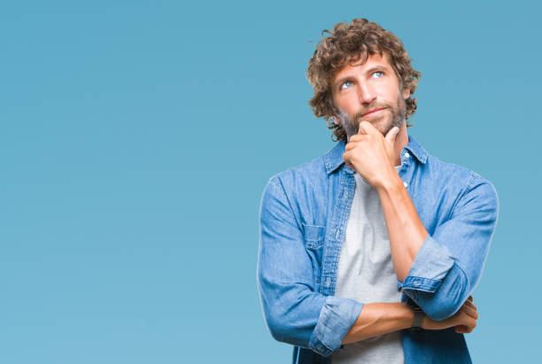 istock Handsome hispanic model man over isolated background with hand on chin thinking about question, pensive expression. Smiling with thoughtful face. Doubt concept. 1042827412