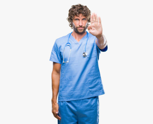 istock Handsome hispanic surgeon doctor man over isolated background doing stop sing with palm of the hand. Warning expression with negative and serious gesture on the face. 1042827650