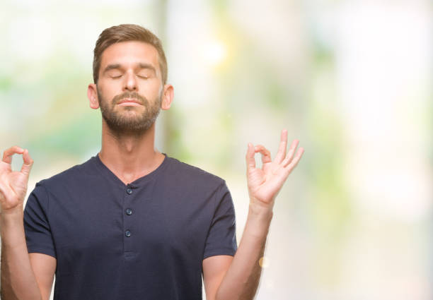 istock Young handsome man over isolated background relax and smiling with eyes closed doing meditation gesture with fingers. Yoga concept. 1042828154