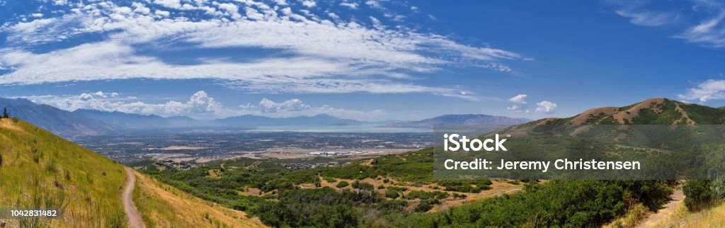 Panoramic Landscape view from Travers Mountain of Provo, Utah County, Utah Lake and Wasatch Front Rocky Mountains, and Cloudscape. Utah, USA. Canyon Stock Photo