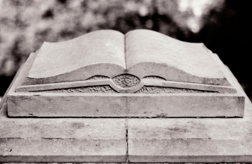 A book carved in stone. Black and white duotone.