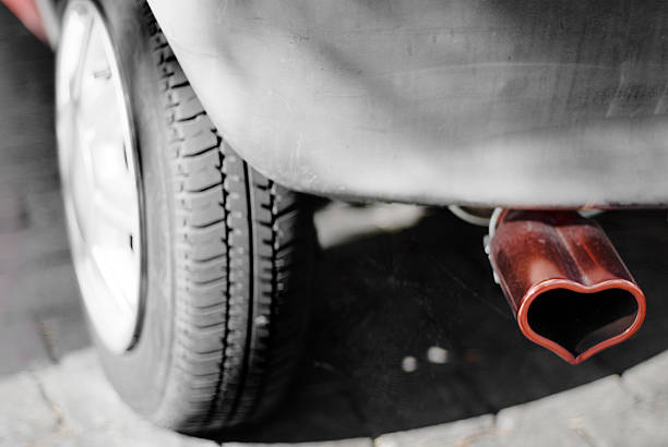 No pollution - Car exhaust pipe embellished by a heart stock photo