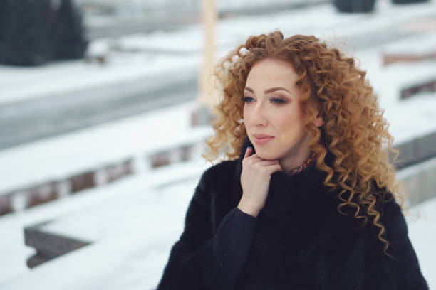 istock Red-haired girl outdoors in winter 1042833220