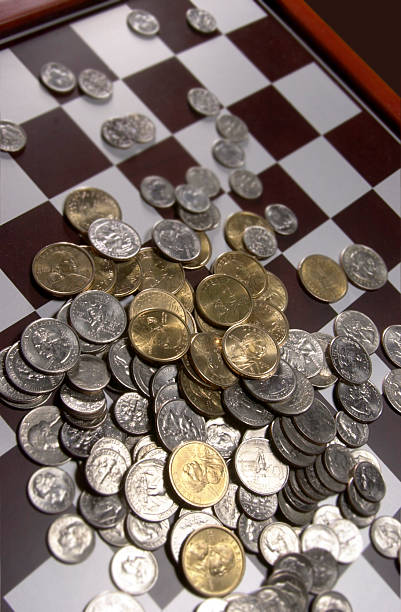 istock American Coins Scattered on Chess Board 104283362