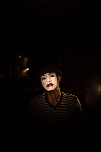 istock Miming people at dark with mask 1042838264