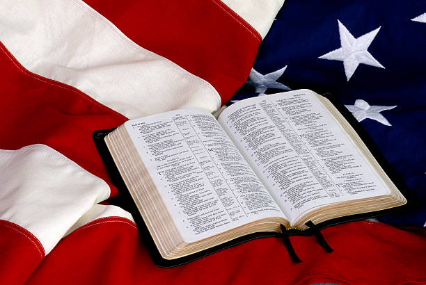 Open Bible on American Flag stock photo