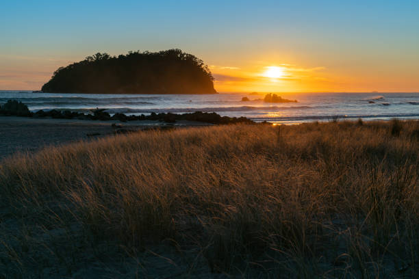 istock Golden sunrise over Mount Maunganui beach 1042846746