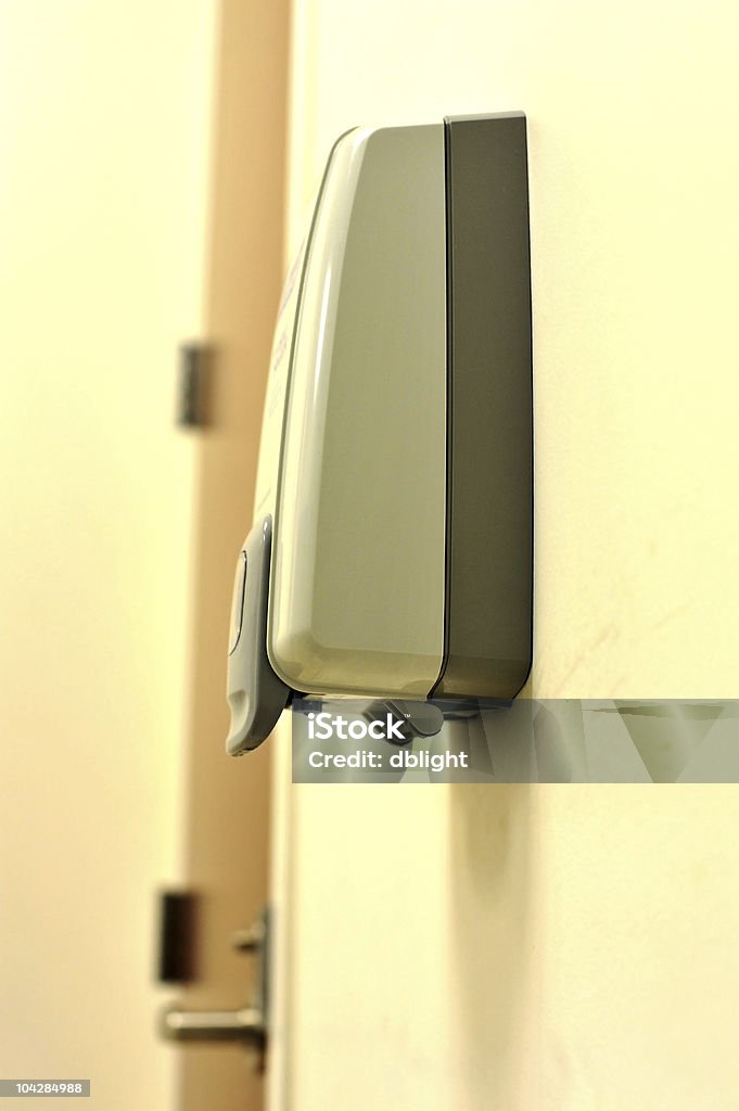 hand sanitizer a hand sanitizer dispenser near the door way to encourage usage for hygence awareness and flu virus prevention. Alertness Stock Photo